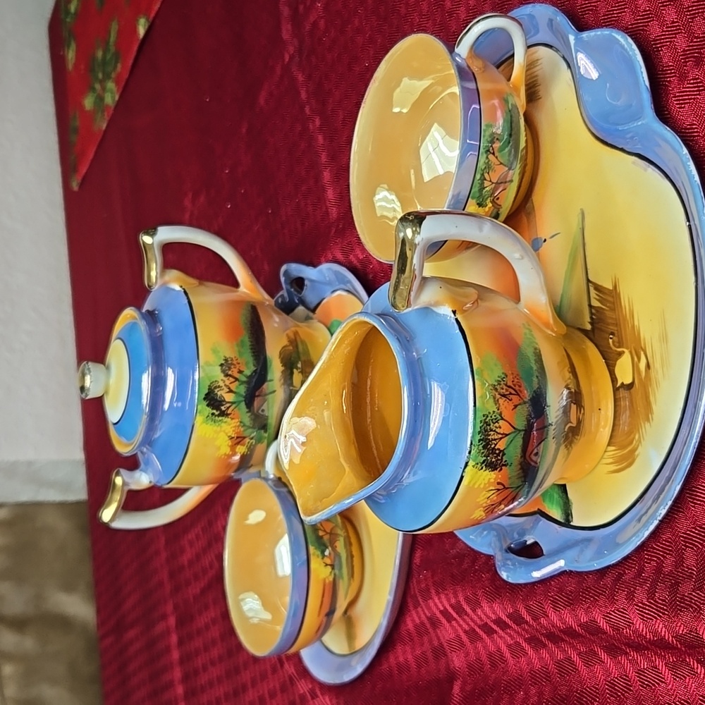 6 piece Japanese tea set, 2 tea cups, 2 trays, 1 creamer, 1 sugar bowl.